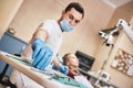 Cavities donÃ¢â¬â¢t scare us! Teen at the dental office. Dentist treats teeth, girl lying in the dental chair Royalty Free Stock Photo